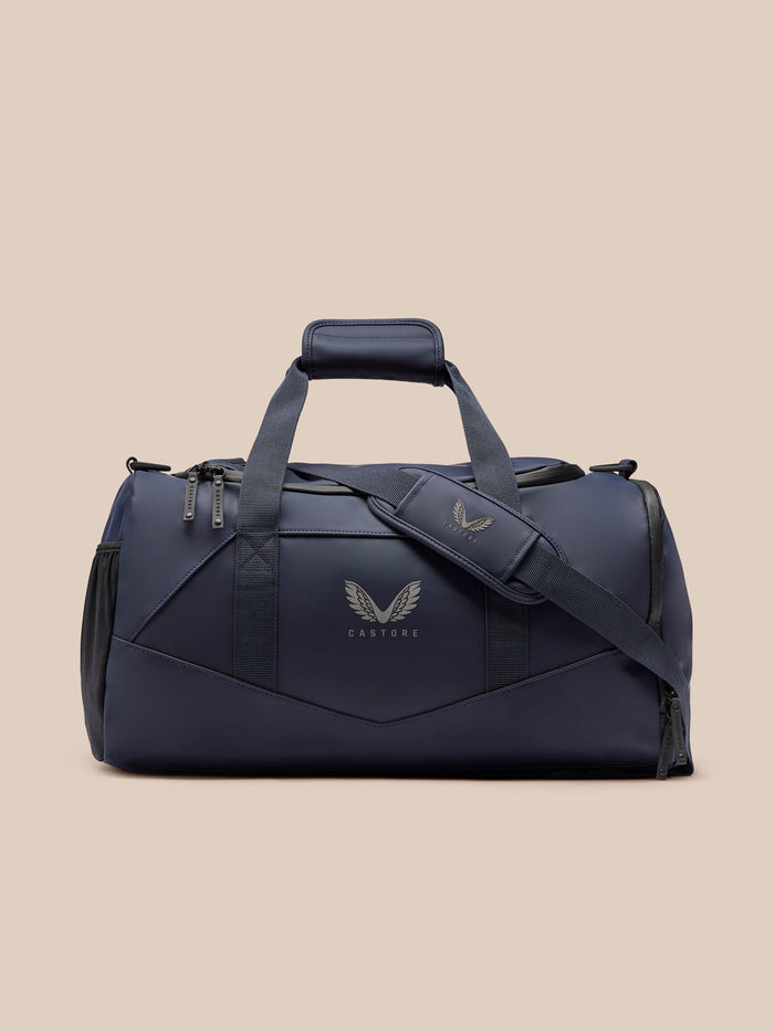 Navy Core Holdall with padded top handle and detachable shoulder strap, front logo and zipped pockets.