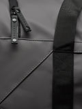 Close up of gunmetal Core Holdall with black strap and branded zipper pulls