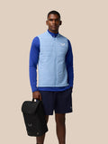 Athlete in blue athletic wear carries a black Castore boot bag during a product shoot.