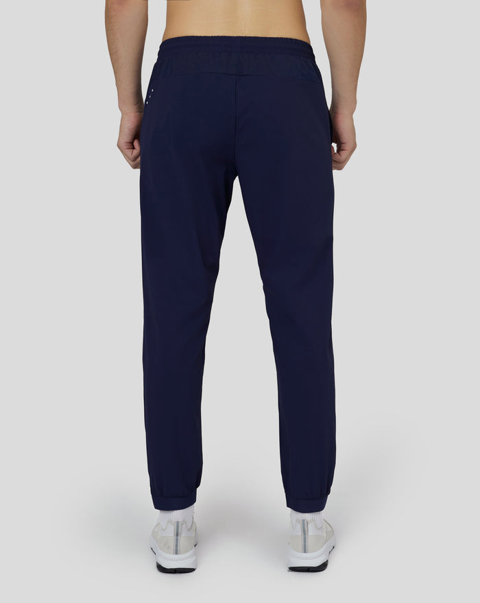Back view of navy Castore woven Active Joggers with mesh ventilation and reflective details