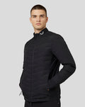 Front view of a man wearing a black Castore Zone Hybride Jacket with full zip and stand collar.