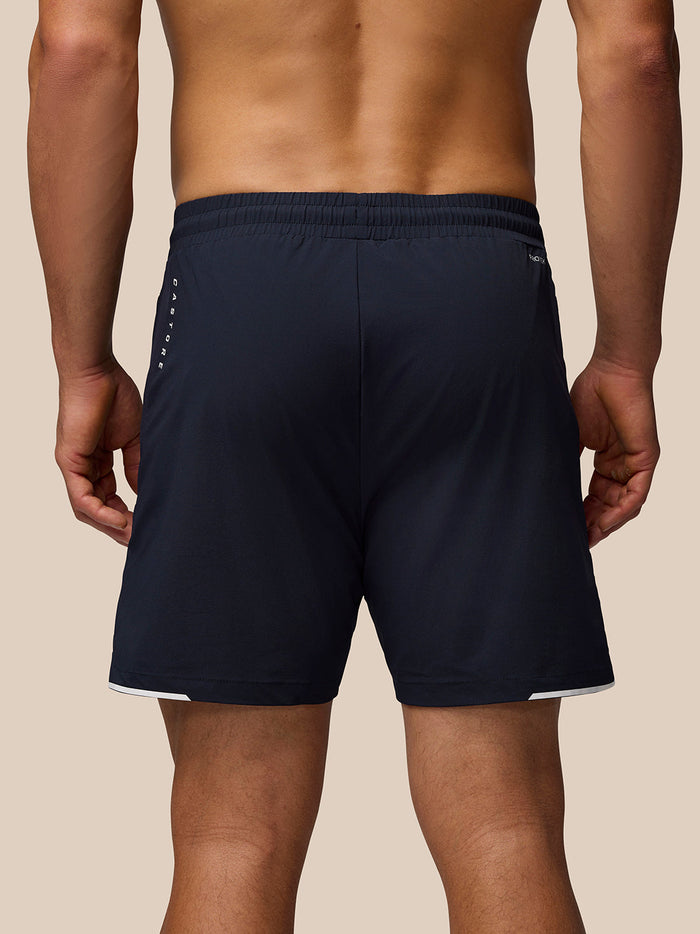 Back view of navy Aeromesh shorts with elastic waistband and Castore wing logo on left leg