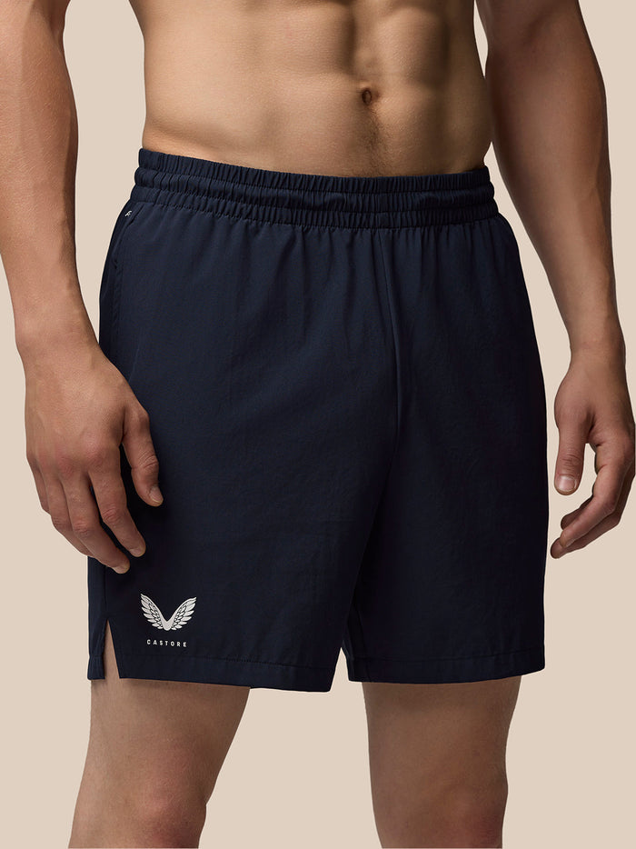 Navy blue Adapt 6 inch Stretch woven shorts for men with elastic waistband and drawcord; Castore logo on the right thigh and Aertek branding on the back.