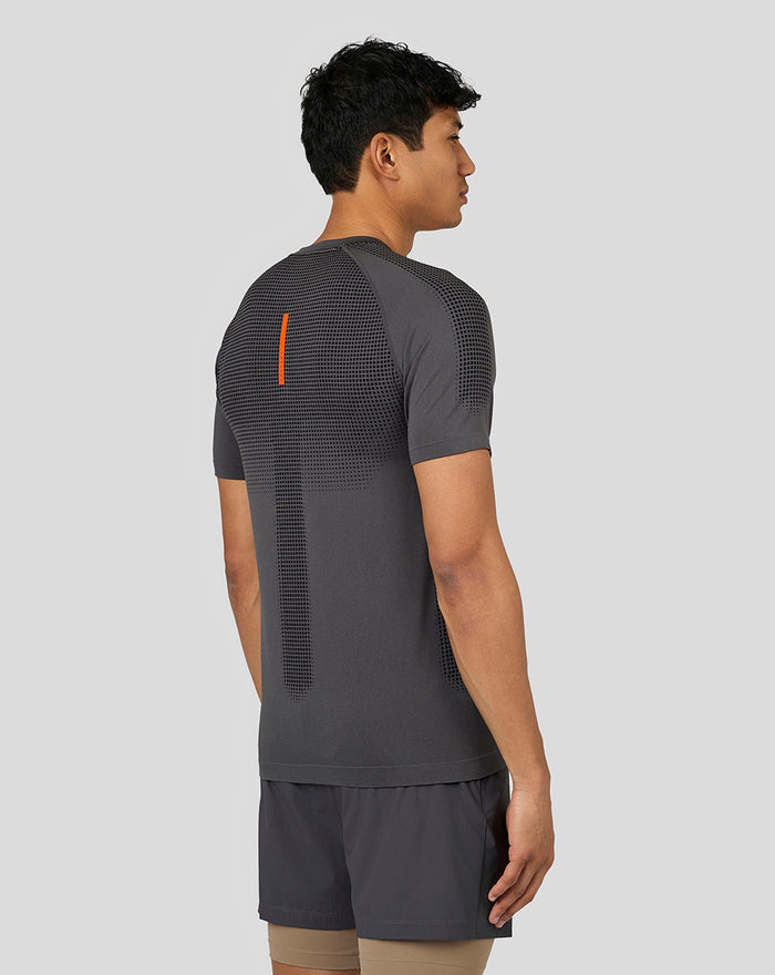 Back view of Castore Flow Training T Shirt in dark gray with dotted back panel