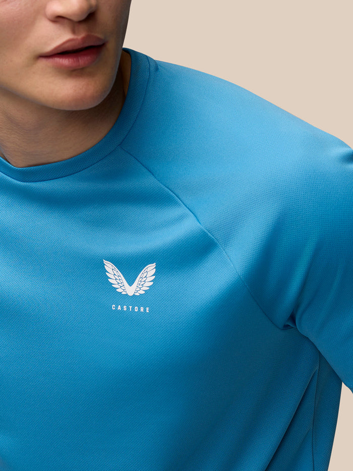 Close-up of blue Adapt Short Sleeve T Shirt fabric with Castore logo on the left chest