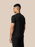 Back view of a man in black Grafisch Training T-Shirt showing the Aertek logo on the lower back.