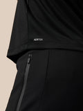 Close-up of the back lower hem on a black Grafisch Training T-Shirt with the Aertek logo.