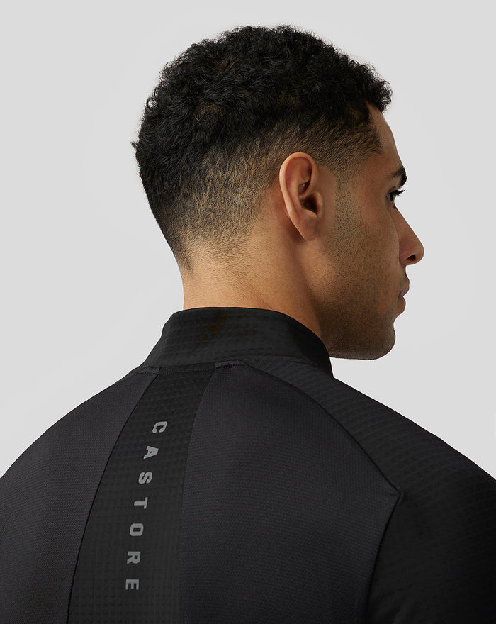Achterkant van zwarte Apex Aeromesh Kwartrits Top met reflecterende Castore branding langs de rug