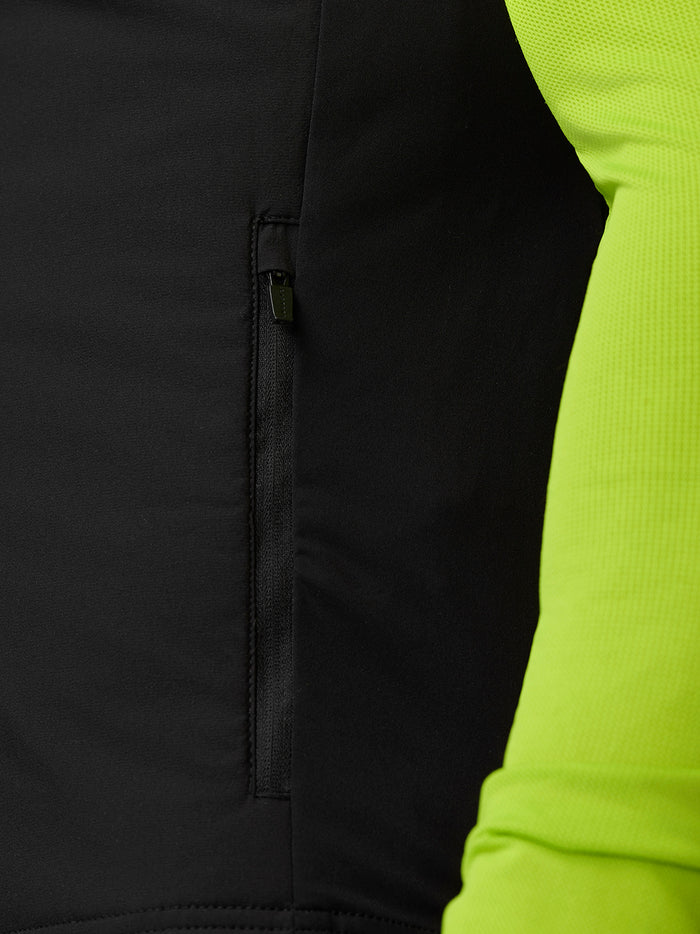 Close up of side zip pocket on black Apex training gilet with neon lime sleeve