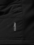 Close up of black Apex Training Gilet showing Protek branding on chest pocket with neon green neckline