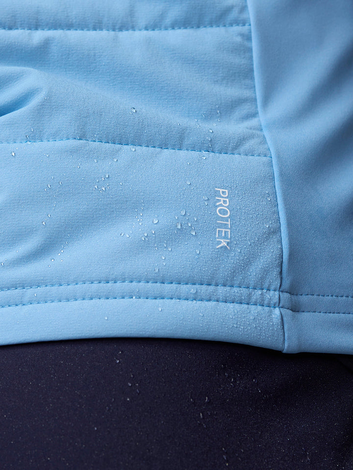 Close-up of light blue fabric showing the ProTek logo and water droplets.