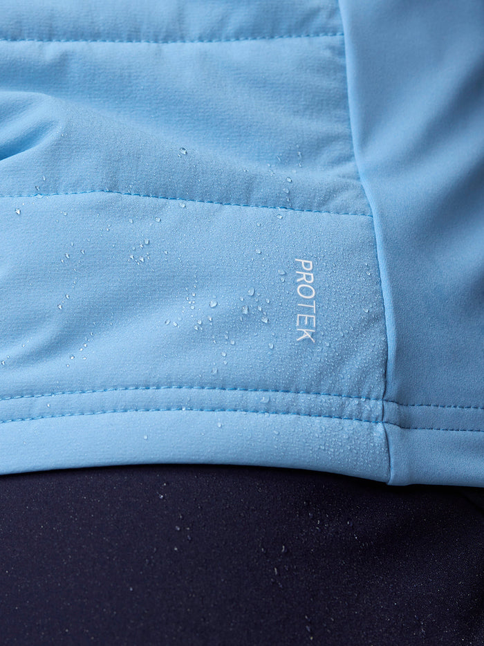 Close-up of light blue fabric showing the ProTek logo and water droplets.