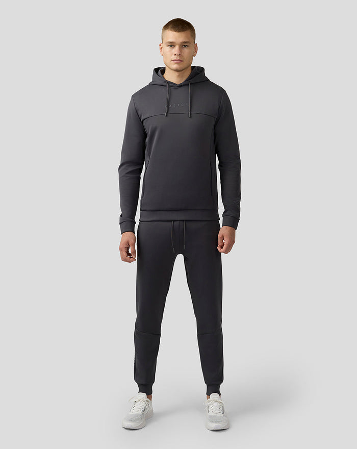 Male model in charcoal Scuba Lightweight Joggers with a matching hoodie, full-body studio shot