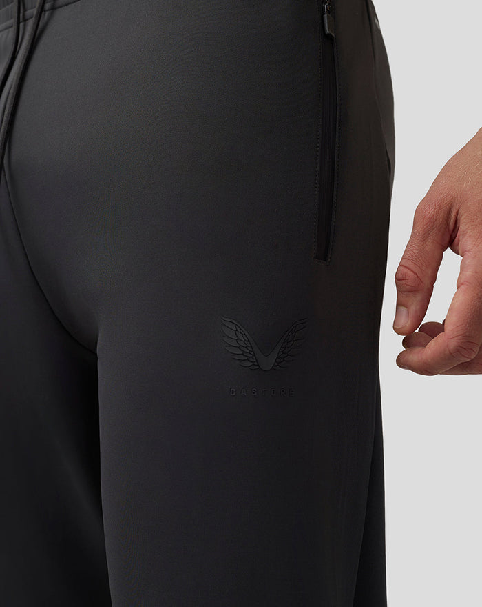 Close-up of dark charcoal Scuba Lightweight Joggers showing an embossed Castore logo on the left thigh