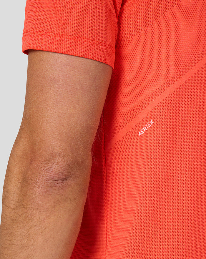 Close up of the orange knit fabric showing mesh texture and Aertek branding on the back panel