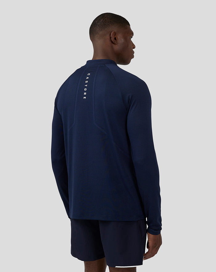 Back view of navy long sleeve Apex top with Castore branding running vertically along the center back