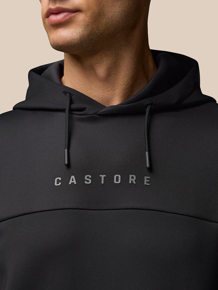 Close-up of a black Flex Hoodie with hood and drawstrings and the CASTORE logo on the chest