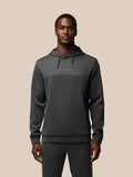 Male model wearing a dark gray Flex Lifestyle Hoodie with hood down and a Castore logo on the chest