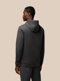 Back view of male model wearing dark gray Flex Lifestyle Hoodie with hood and clean silhouette