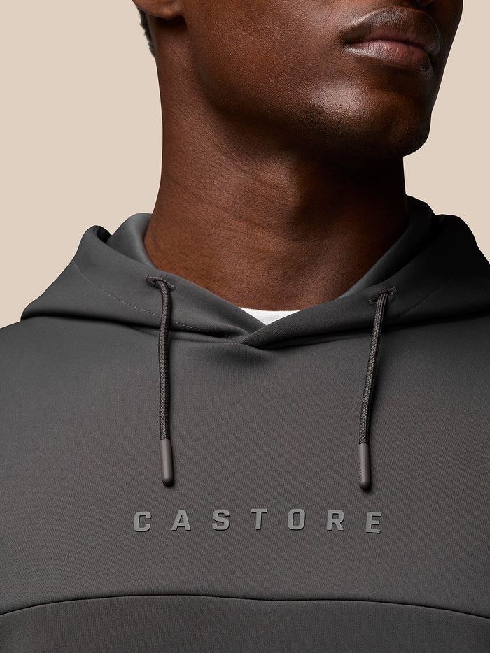 Close-up of the dark gray Flex Lifestyle Hoodie showing drawstring hood and Castore logo on the chest