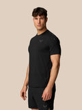 Side view of a man wearing black Apex Training T-Shirt and shorts with the Castore logo on the chest