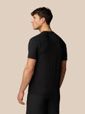 Back view of man in black Apex Training T-Shirt with mesh panels under the arms and reflective Castore logo