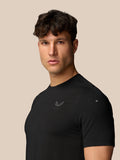 Angled front view of man in black Apex Training T-Shirt showing chest Castore logo and reflective sleeve detail