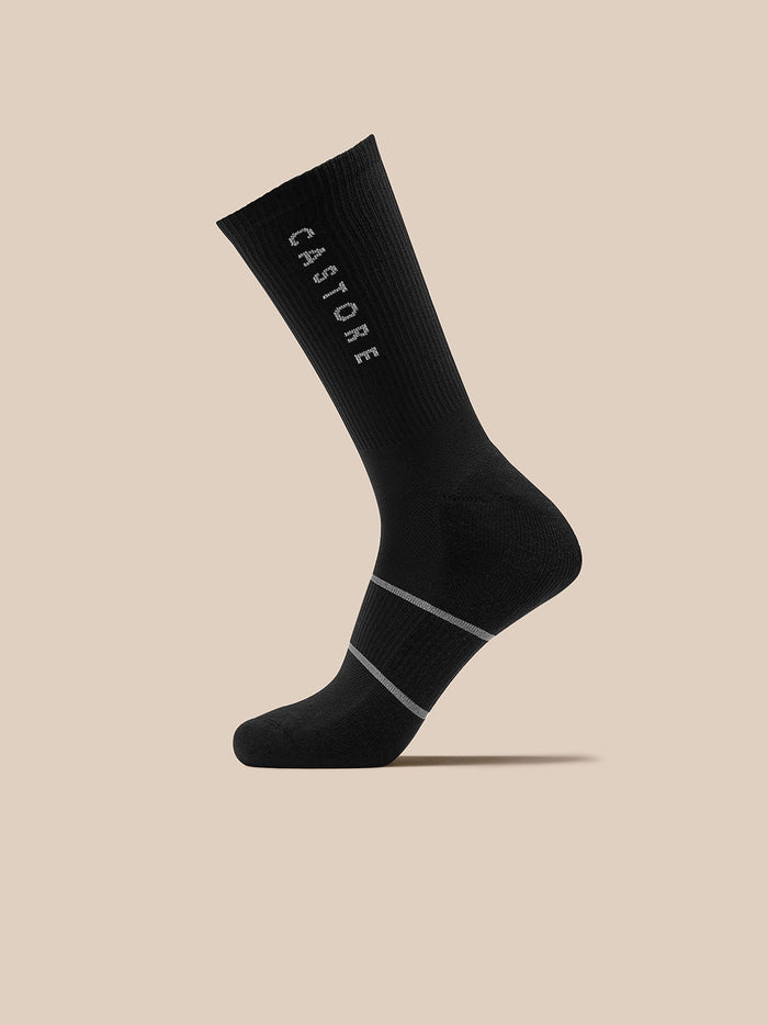 Black crew socks with Castore branding and contrasting gray stripes