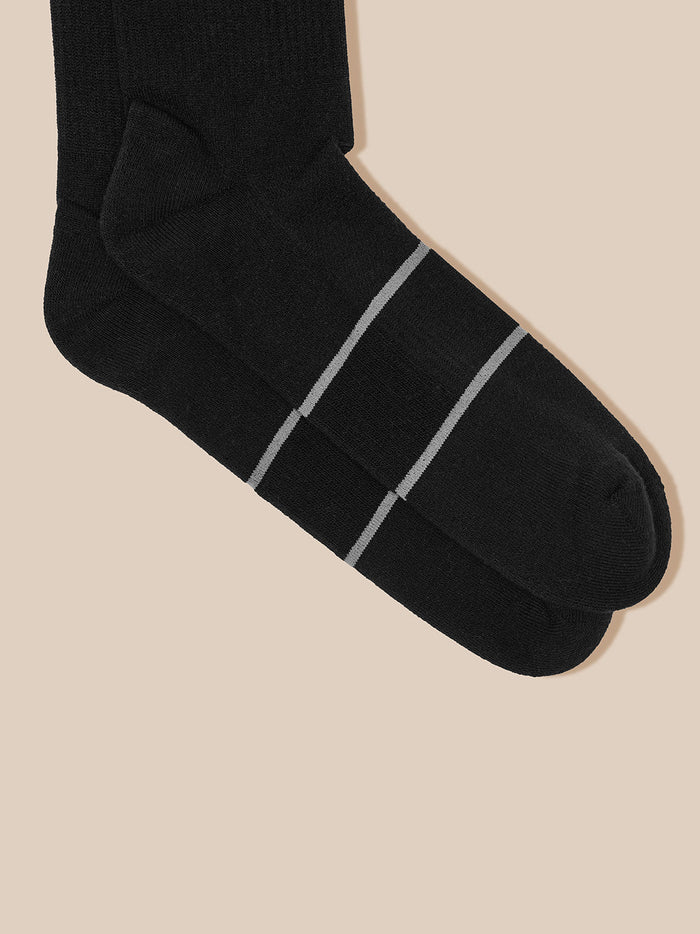 Black crew sock with two light gray stripes near the toe