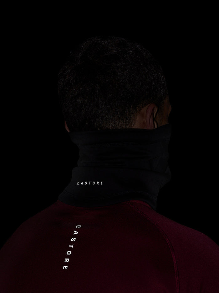 Back view of a person wearing a black Castore unisex core snood around the neck