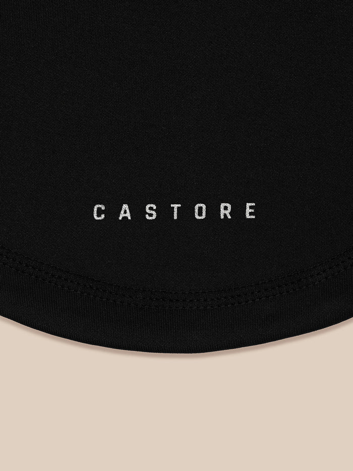 Close-up of black fabric with CASTORE branding and stitched curved hem