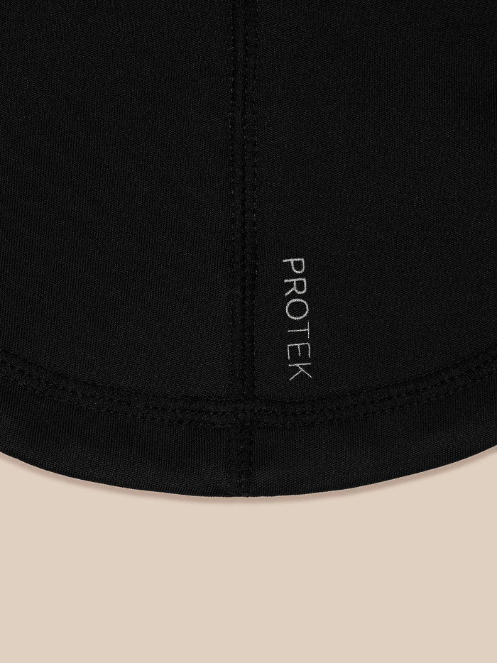 Close up of black neck warmer fabric with vertical PROTEK branding along the seam