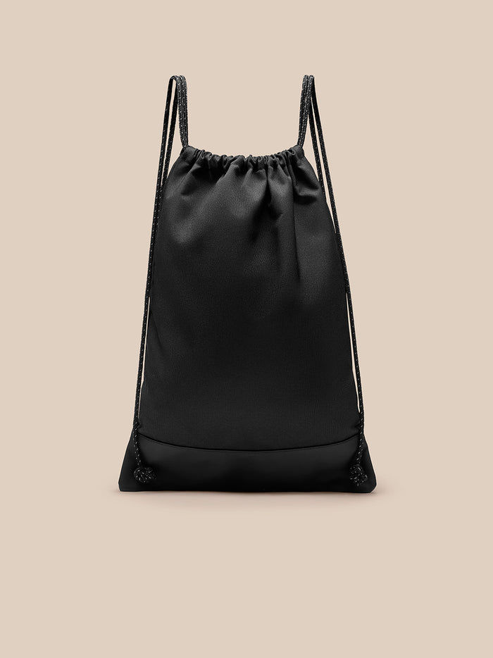 Back view of black Castore gym bag with drawstring closure and reinforced base panel