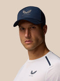 Male model wearing navy Castore cap with wing logo, close-up portrait