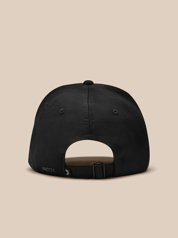Back view of black Castore cap showing adjustable strap and PROTEK branding