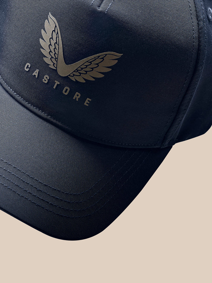 Navy unisex nylon cap with halo eyelets and Castore logo, close-up angled shot