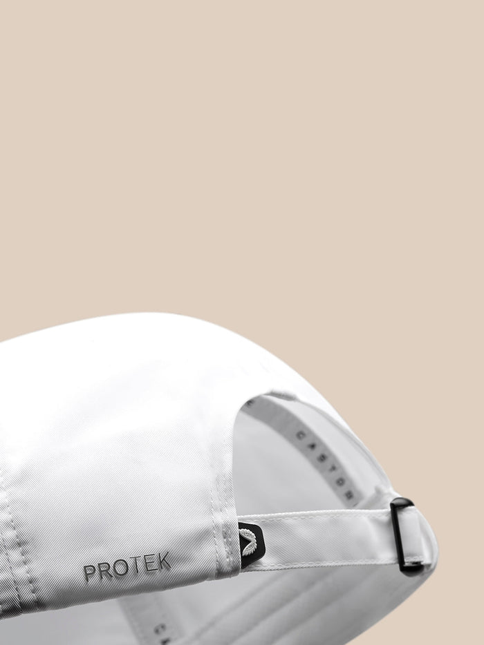 Close up of the back of a white cap showing an adjustable strap and ProTek lettering