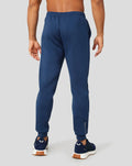Back view of blue Ore Capsule joggers with elastic cuffs and branding on the lower leg.