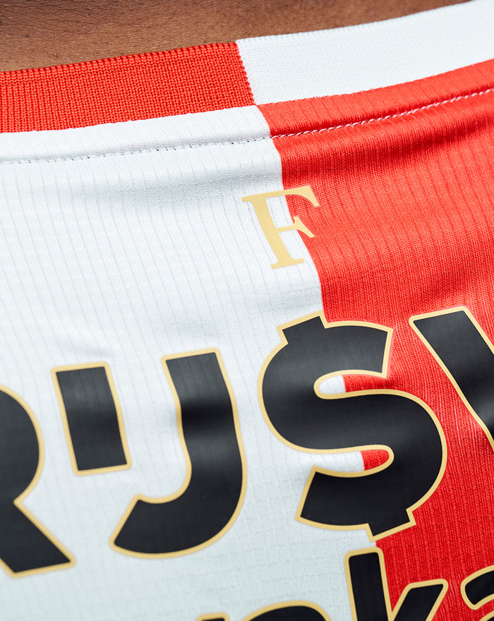 Back view of Feyenoord Pro home shirt 2025-2026 for men with red and white panels and large sponsor text across the upper back