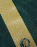 Gold embossed name strip with numerous tiny letters and a Feyenoord crest on dark green fabric.