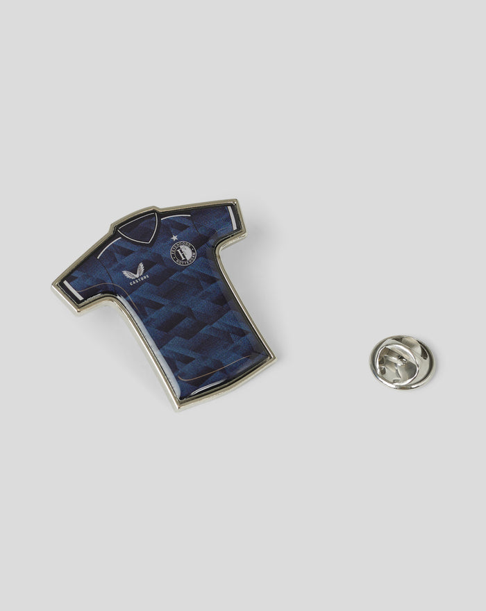 Partial view of a Feyenoord pin showing a blue geometric pattern and the club crest