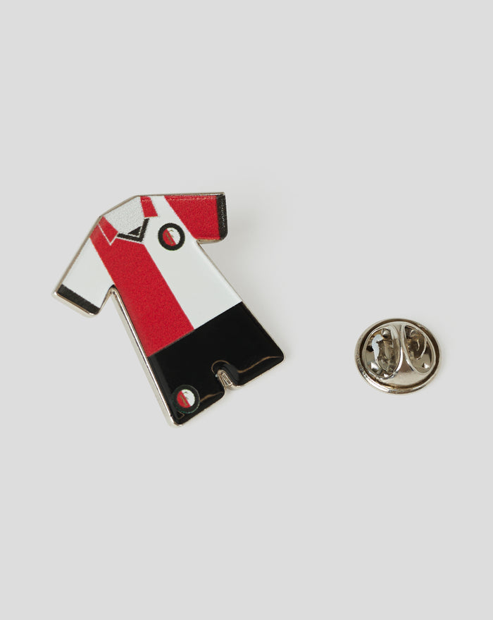 Close up of a retro Feyenoord pin showing red white and black blocks and a stylized F