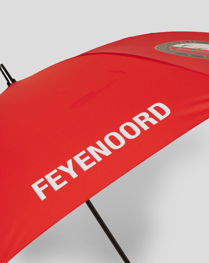 Red Feyenoord golf umbrella close up with logo on the canopy and a black shaft visible.