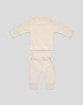 Back view of beige baby top with red trim and matching pants with white drawstring