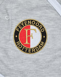 Gray baby romper with circular Feyenoord Rotterdam logo patch.