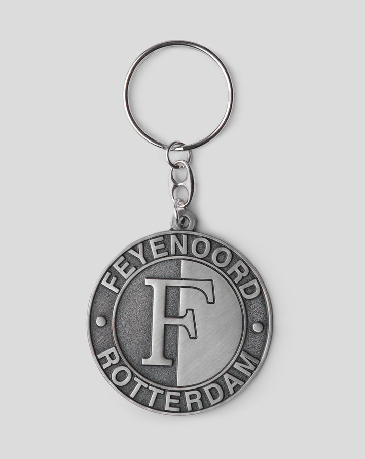 Close up of a silver metal keyring with a round pendant featuring the Feyenoord Rotterdam crest