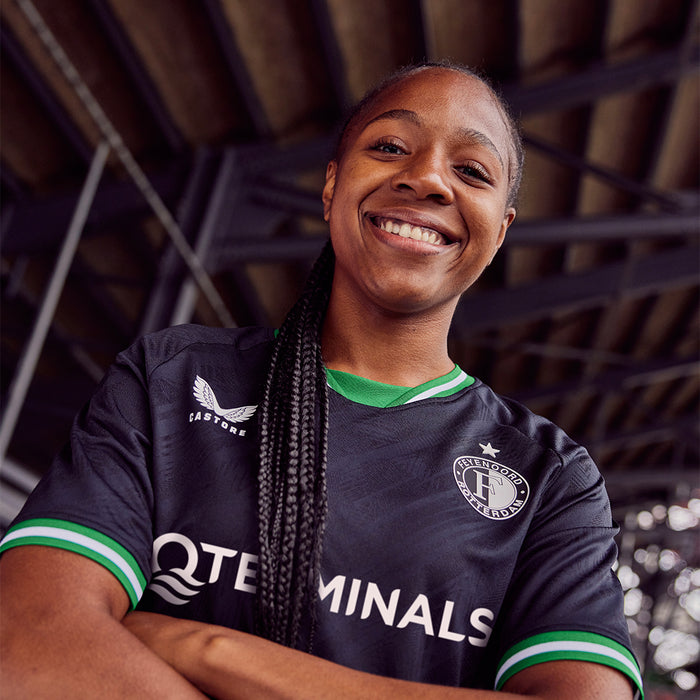 Female athlete wearing the Feyenoord 2024-25 away jersey in black with green trim and left chest crest.