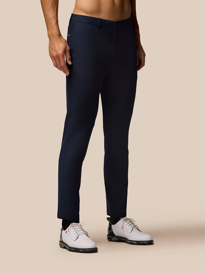 Golf Club broek in donker marine voor model van achteren, geweven rekstof met open zijzakken en logo op voor- en achterzak