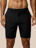 Back view of black golf shorts with belt showing Castore logo on the right thigh and rear