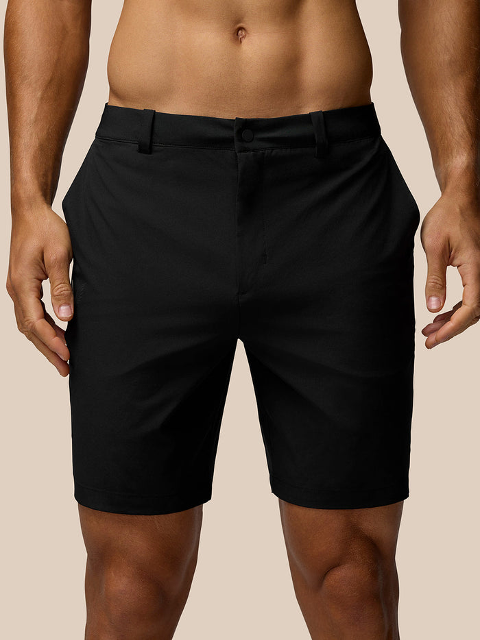 Back view of black golf shorts with belt showing Castore logo on the right thigh and rear